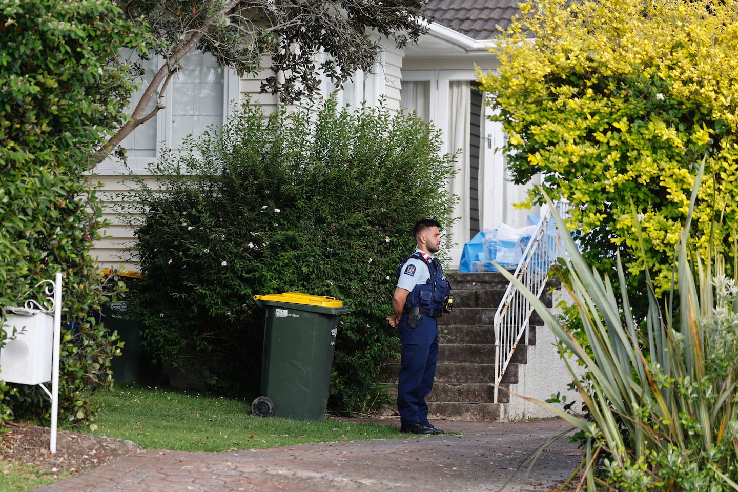 Police on Brandon Rd in Glen Eden after a woman was stabbed to death. Photo / Michael Craig