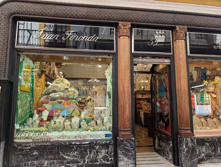 A bustling shopping street in Seville, offering diverse retail options.