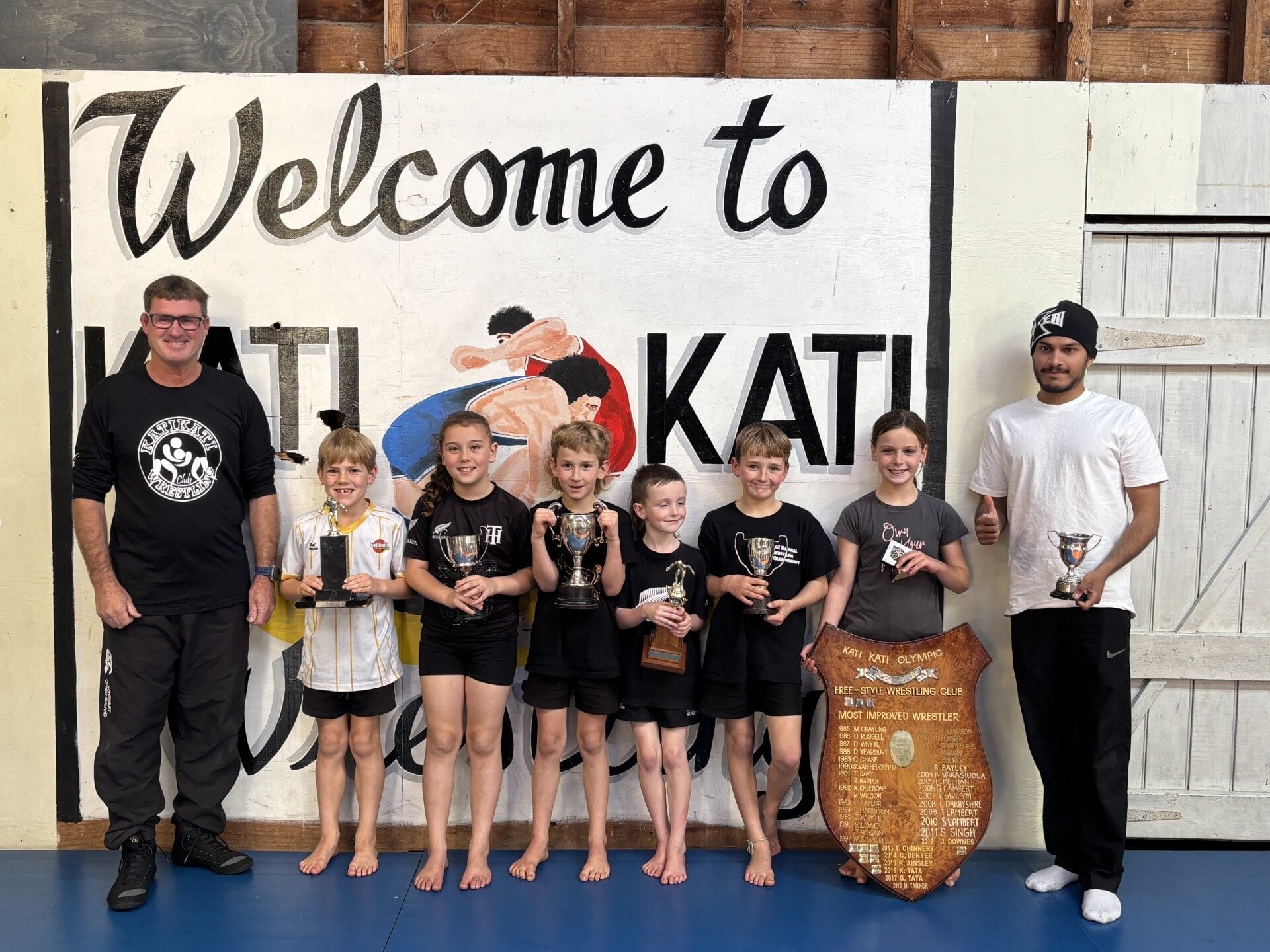  Katikati Olympic Freestyle Wrestling Club coach Ross Tanner, with prizegiving winners Ashton Hunter, Onyx Cottrell, Quinn Clark, Dusty Boyes, Ollie Clark, Eden Cave and Suraj Singh, Photo / Supplied