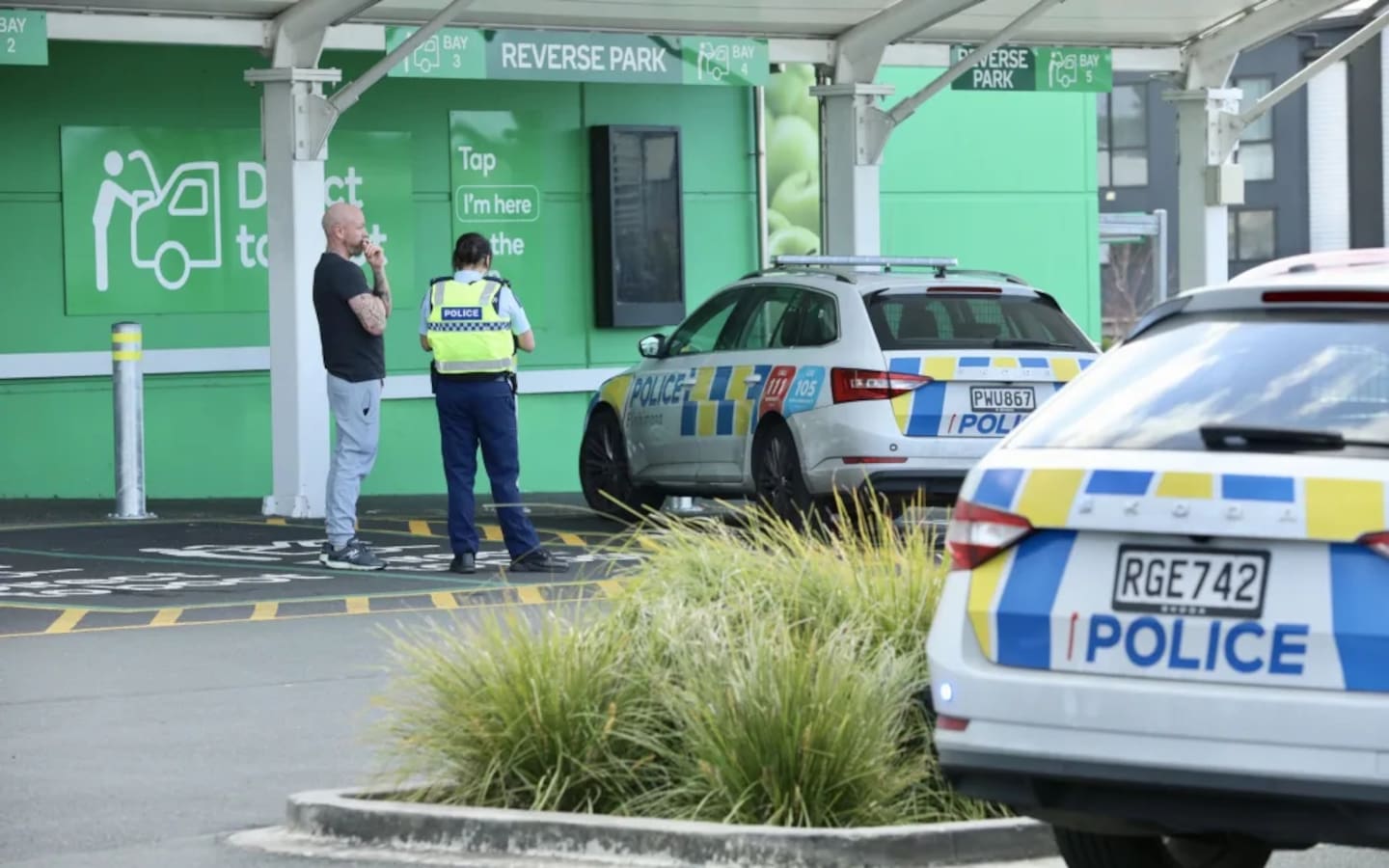 Police outside the Hobsonville Woolworths on Tuesday afternoon. Photo / RNZ, Calvin Samuel