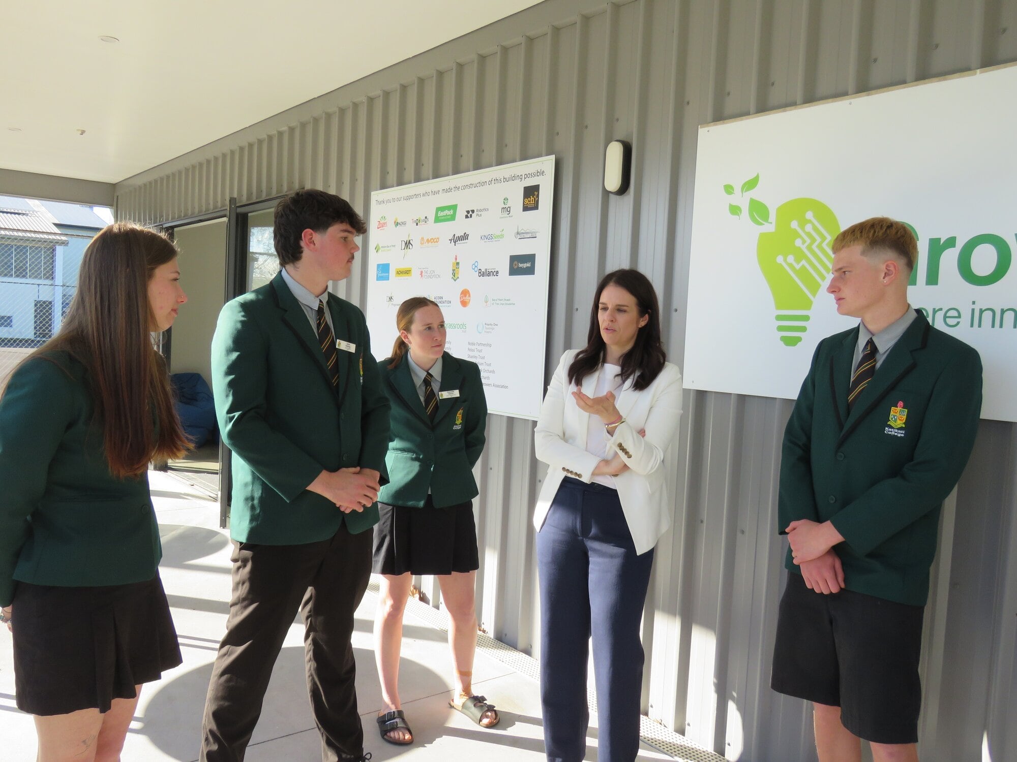  Katikati College senior students talk to Education Minister Erica Stanford outside GrowHub on July 25. Photo / Merle Cave