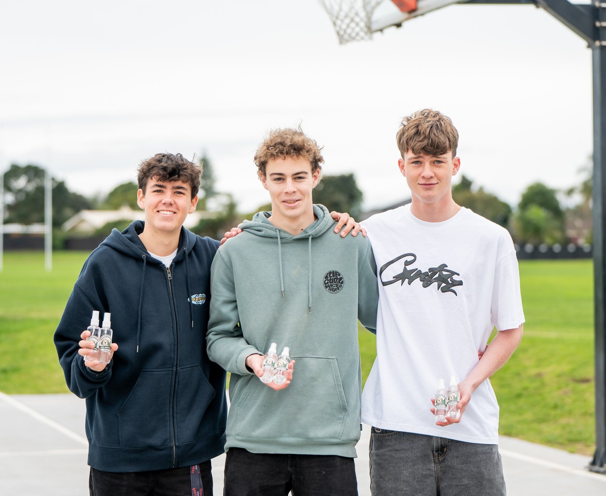 Mount Maunganui College year 13 students Corban Willson, 18, Cooper Everett, 18, and Ollie Breed, 17, with their product, ‘Dogodorant Spray’. Photo / Brydie Thompson