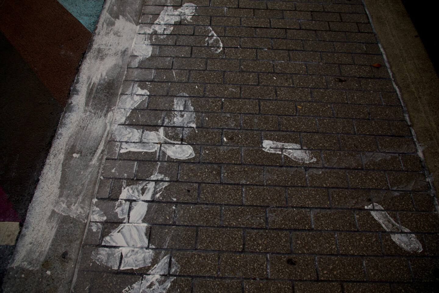 White paint has been spread along the road and footpath by pedestrians and drivers after the rainbow crossing was painted over. Photo / Michael Craig