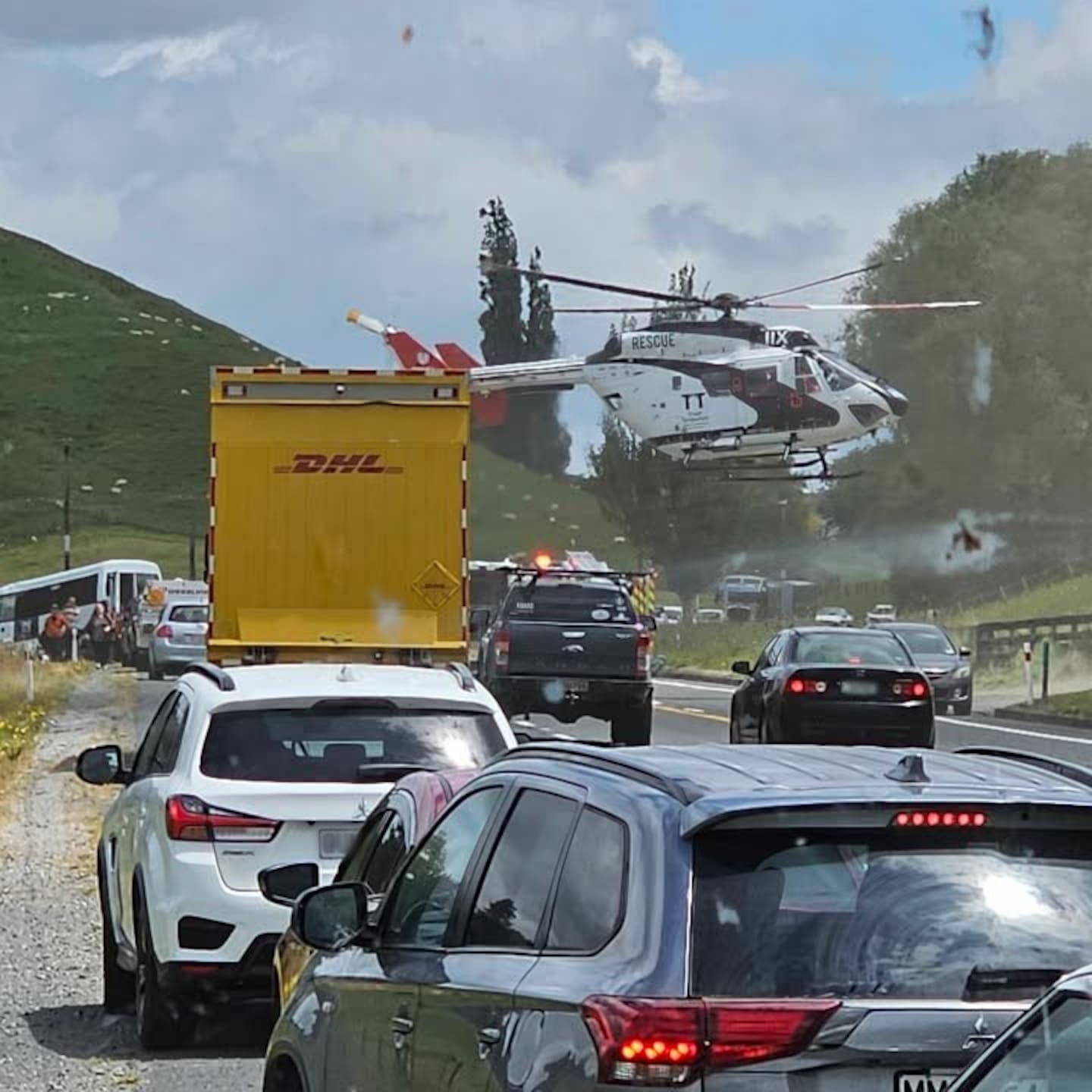 A rescue helicopter lands on State Highway 1 in Waikato following a fatal two-vehicle crash which left 13 people with injuries on Wednesday, November 27, 2024.