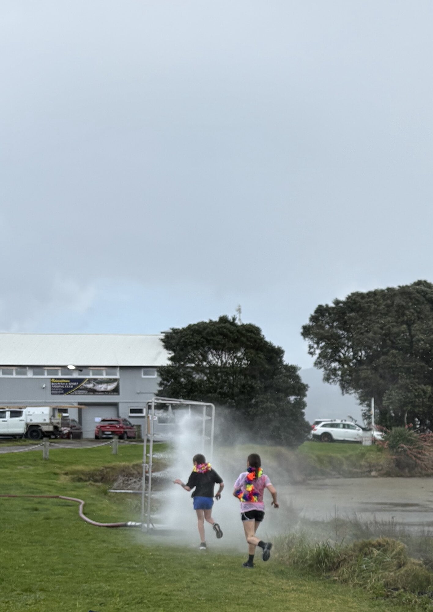 Participants in the Whānau Dash & Splash Mud Walk heading to the Mayor View Fire Brigade’s Decon shower which sprays water.  Photo / Supplied