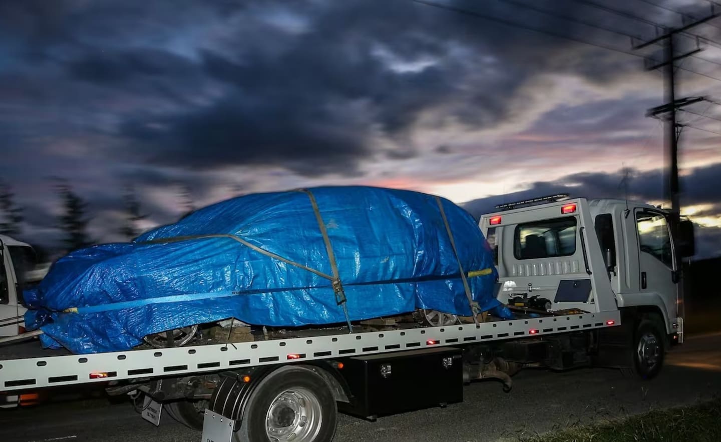 The burnt-out car is removed from Irongate Rd, Flaxmere, in March.  Photo / Paul Taylor