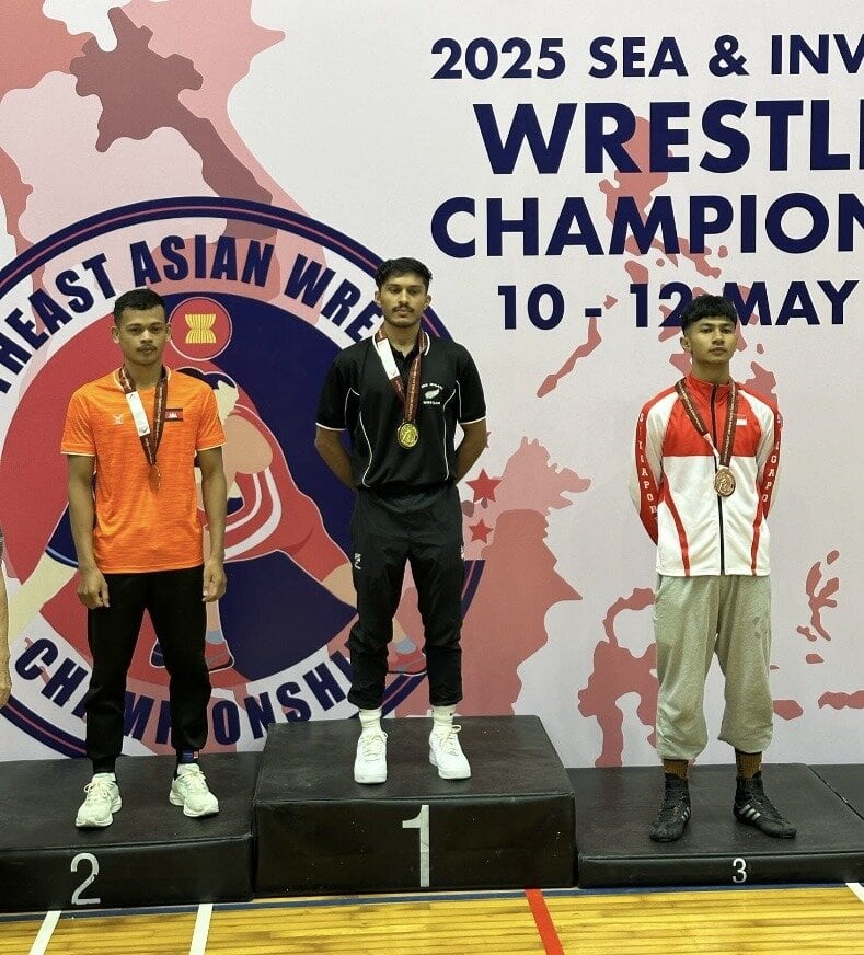  Suraj Singh atop of the podium for the Under-61kg freestyle division medal presentation in Singapore. Photo / Supplied