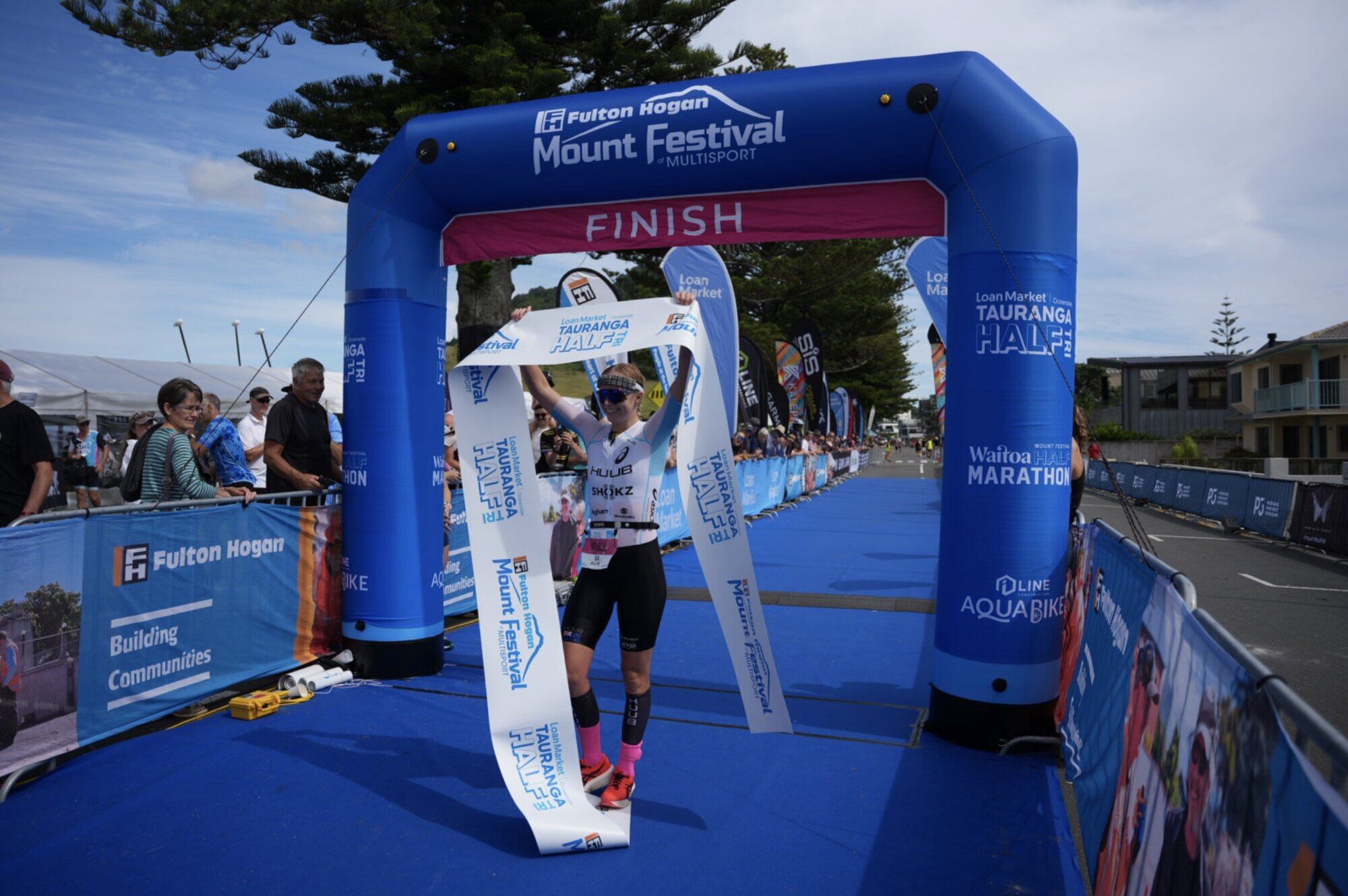  Nicole van der Kaay crossing the finish line of the Loan Market Oceanside Tauranga Half at the weekend. Photo / Supplied