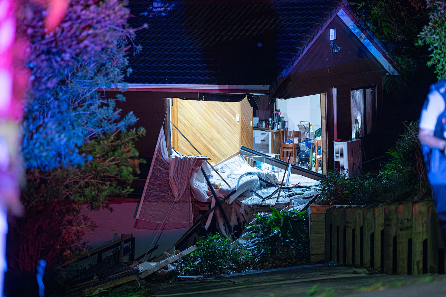 A driver fled on foot after crashing into houses on Don Buck Rd. Photo / Hayden Woodward.