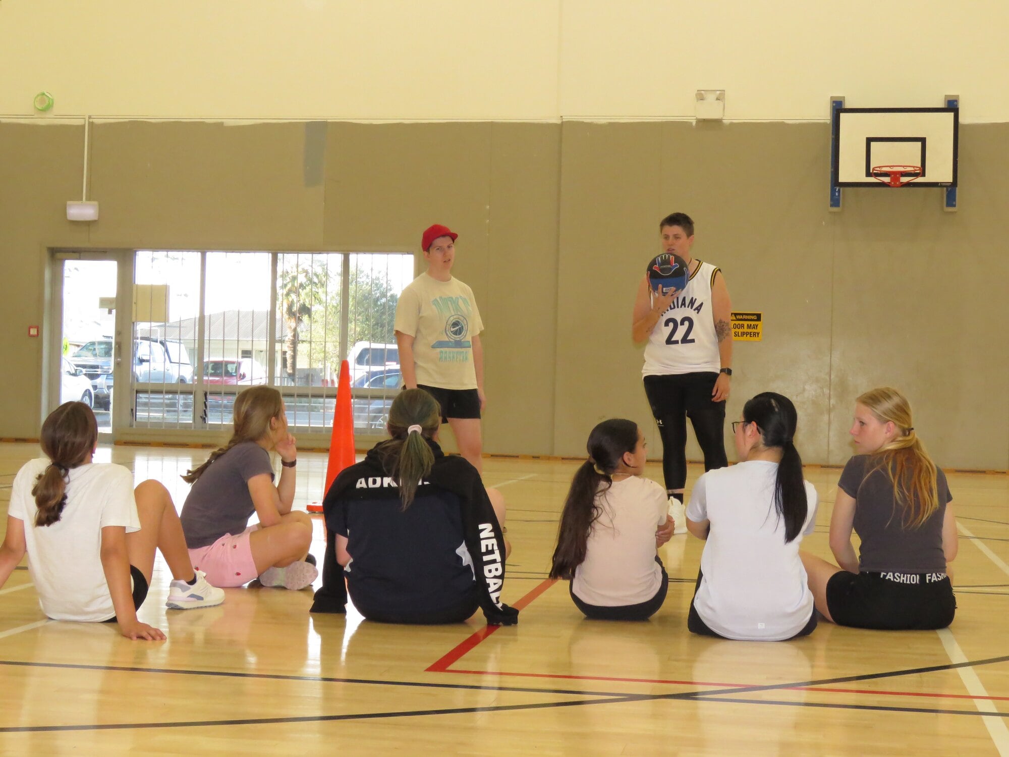  A bunch of girls listen to Maddy Kilford and Sheanna Chadwick talk basketball skills at the Thursday night session for Years 6-12 on October 16. Photo / Merle Cave