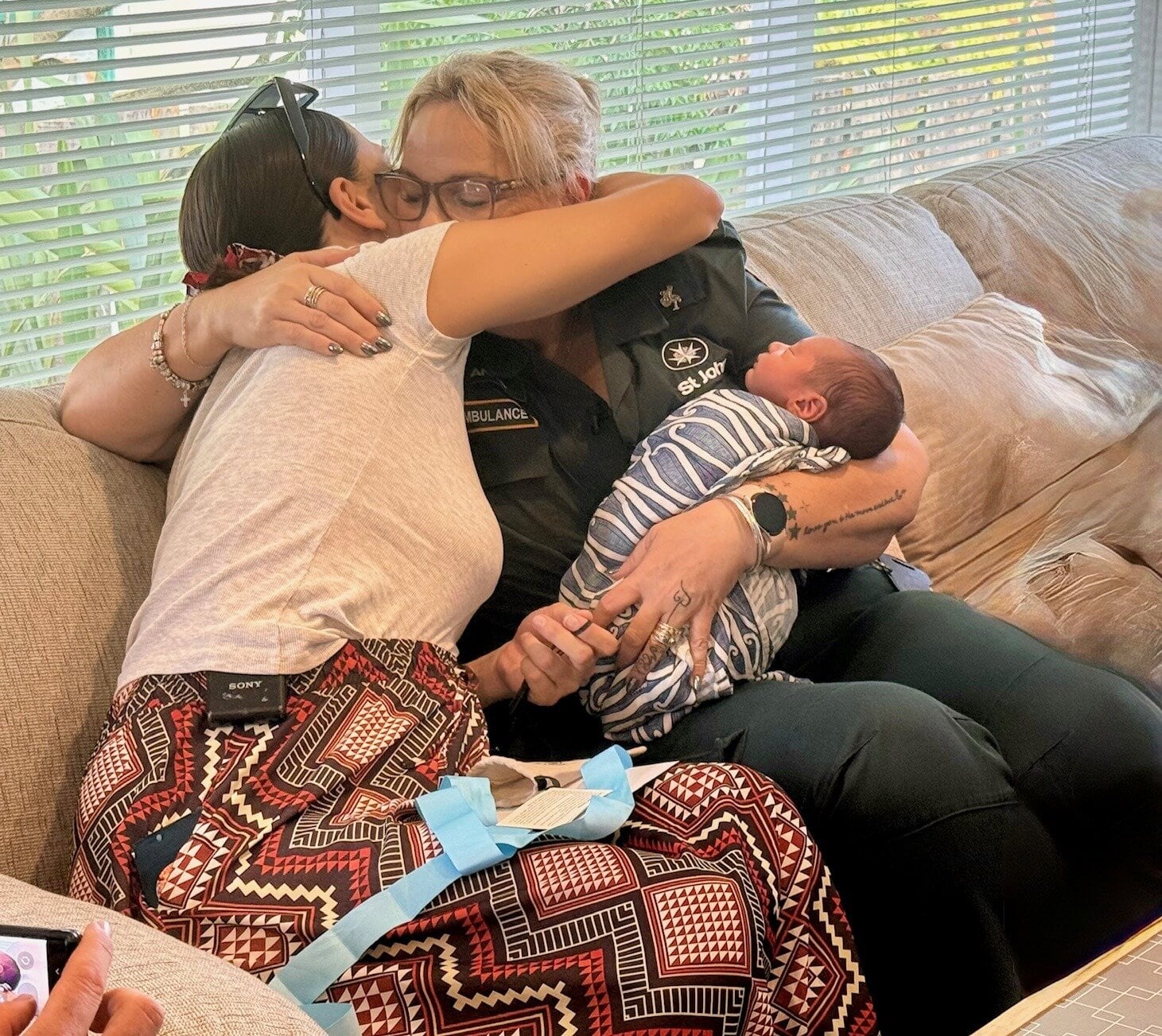  Lia Milich (left), and St John emergency call handler Anna Evans holding Luka Milich. Photo / Hone Hato St John