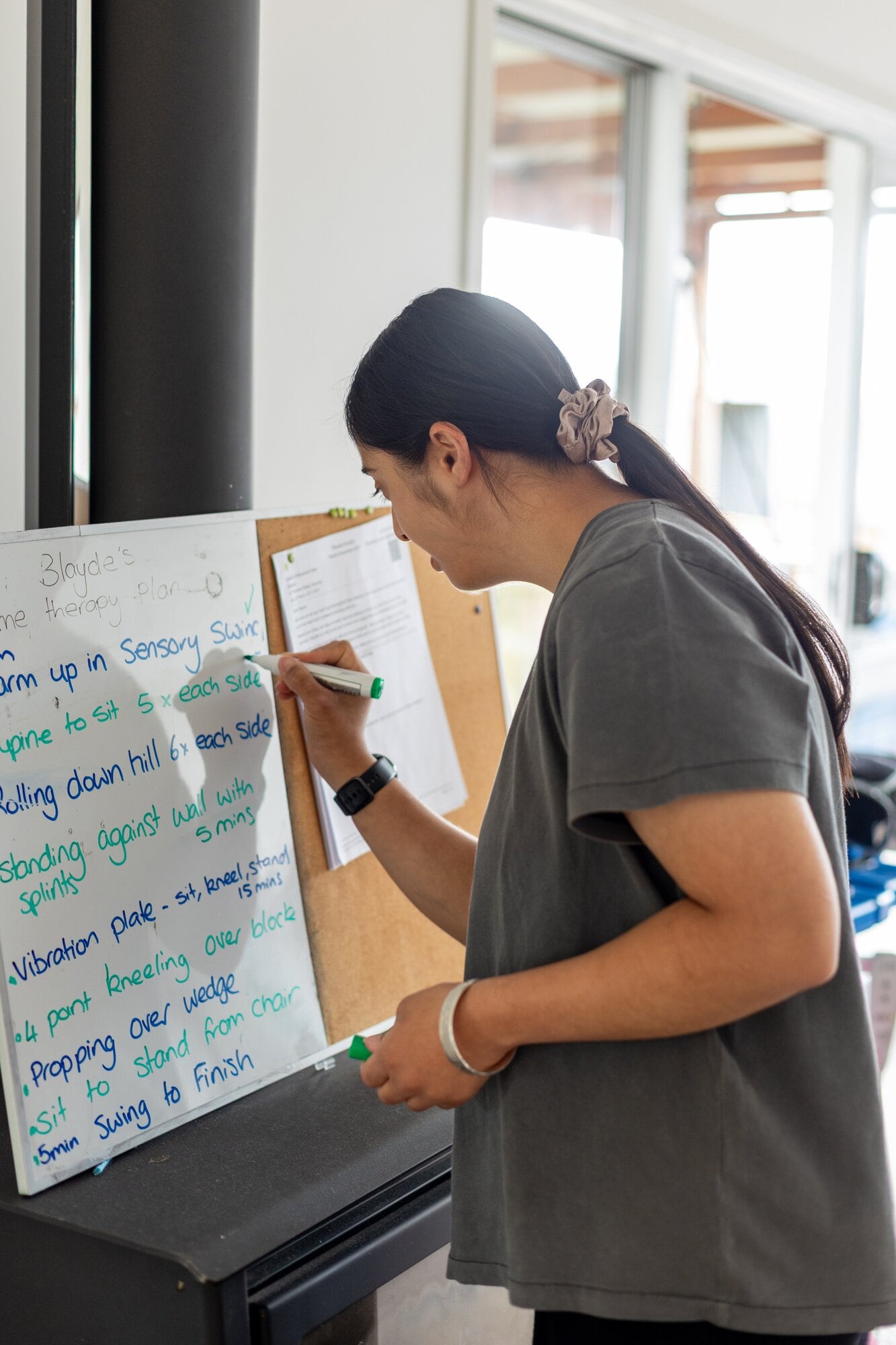  Ruhani Chauhan checking off the exercises she is helping 5-year-old Blayde Arnold with every Sunday. Photo / Natalie Murdoch