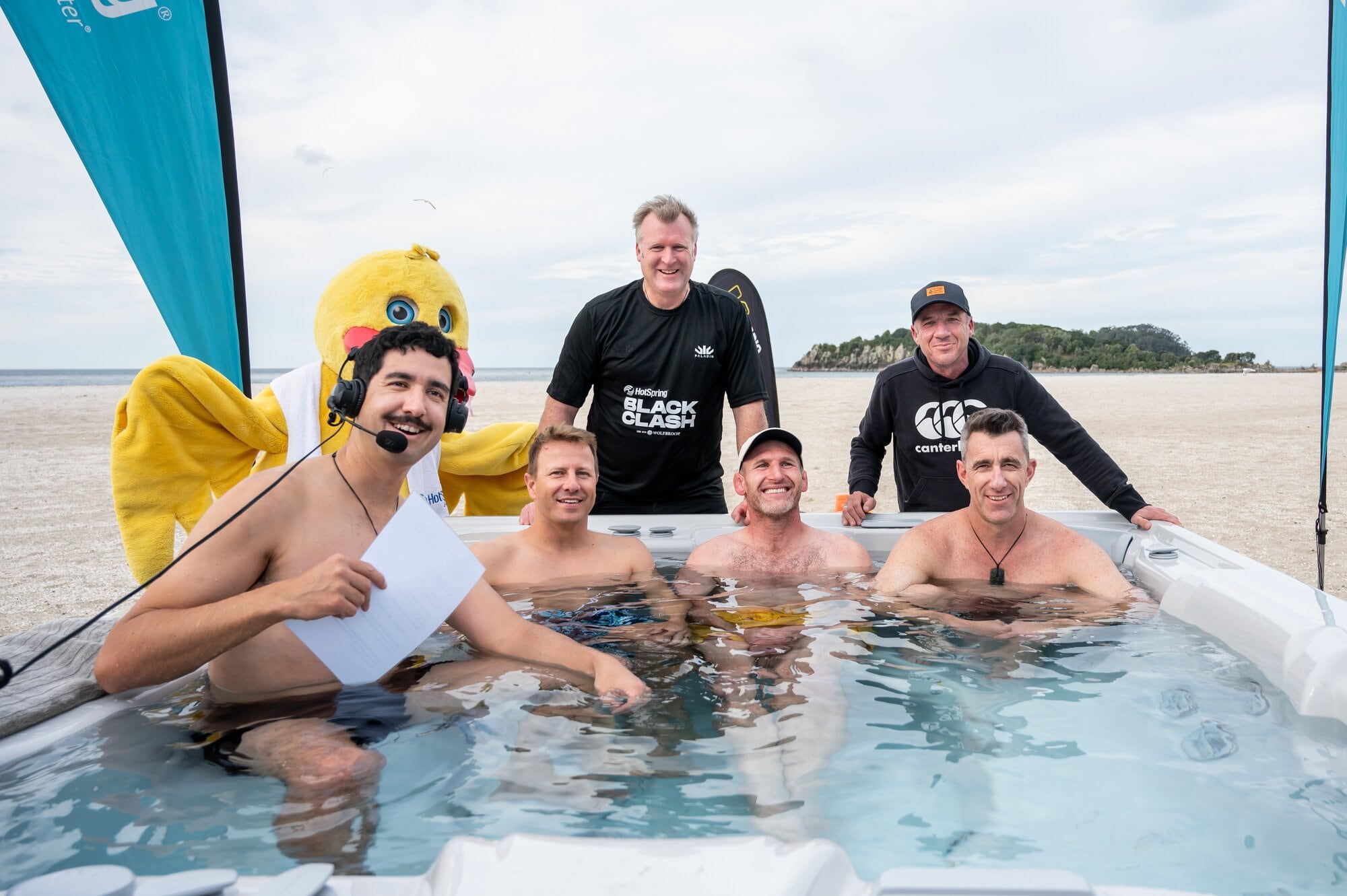 Radio host Chris Key with Neil Wagner, Kieran Read and Mike Minogue from Radio Hauraki's Big Show (all in the pool), Tauranga Mayor Mahé Drysdale and Jason Hoyte, Alternative Commentary Collective commentator. Photo / Brydie Thompson