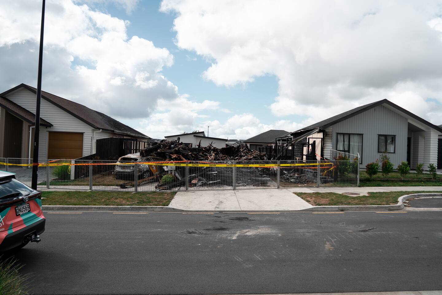 Charred remains of a house fire in Milldale, Auckland. Photo / Carson Bluck