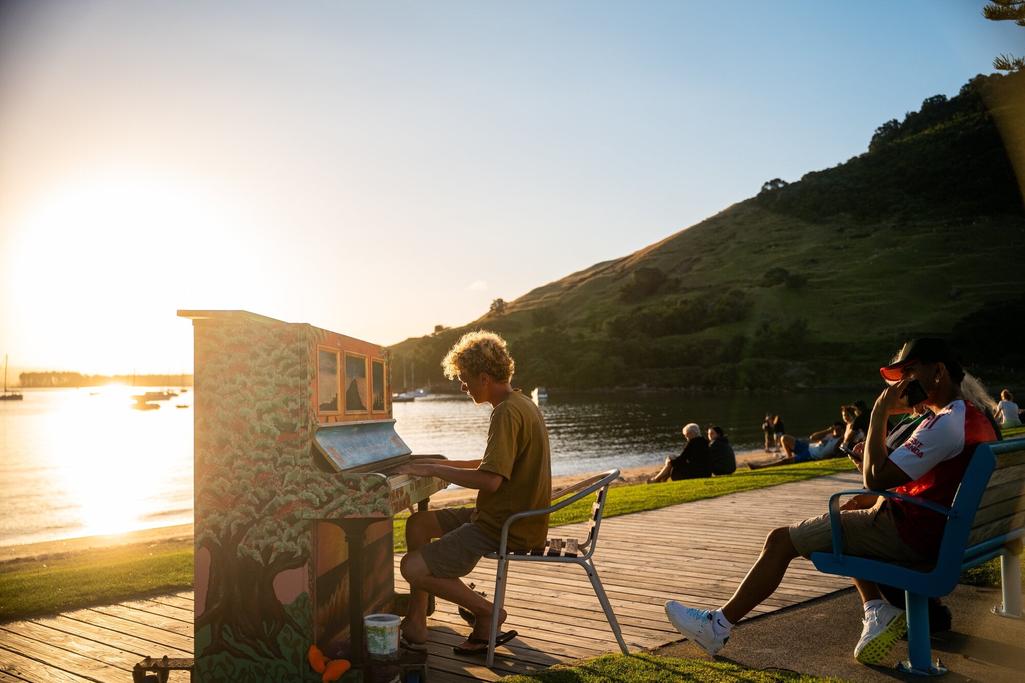 Harry Carpenter playing the Mount Maunganui beach piano in Pilot Bay. The Mount has been voted New Zealand's Best City Beach. Photo / Corey Fleming