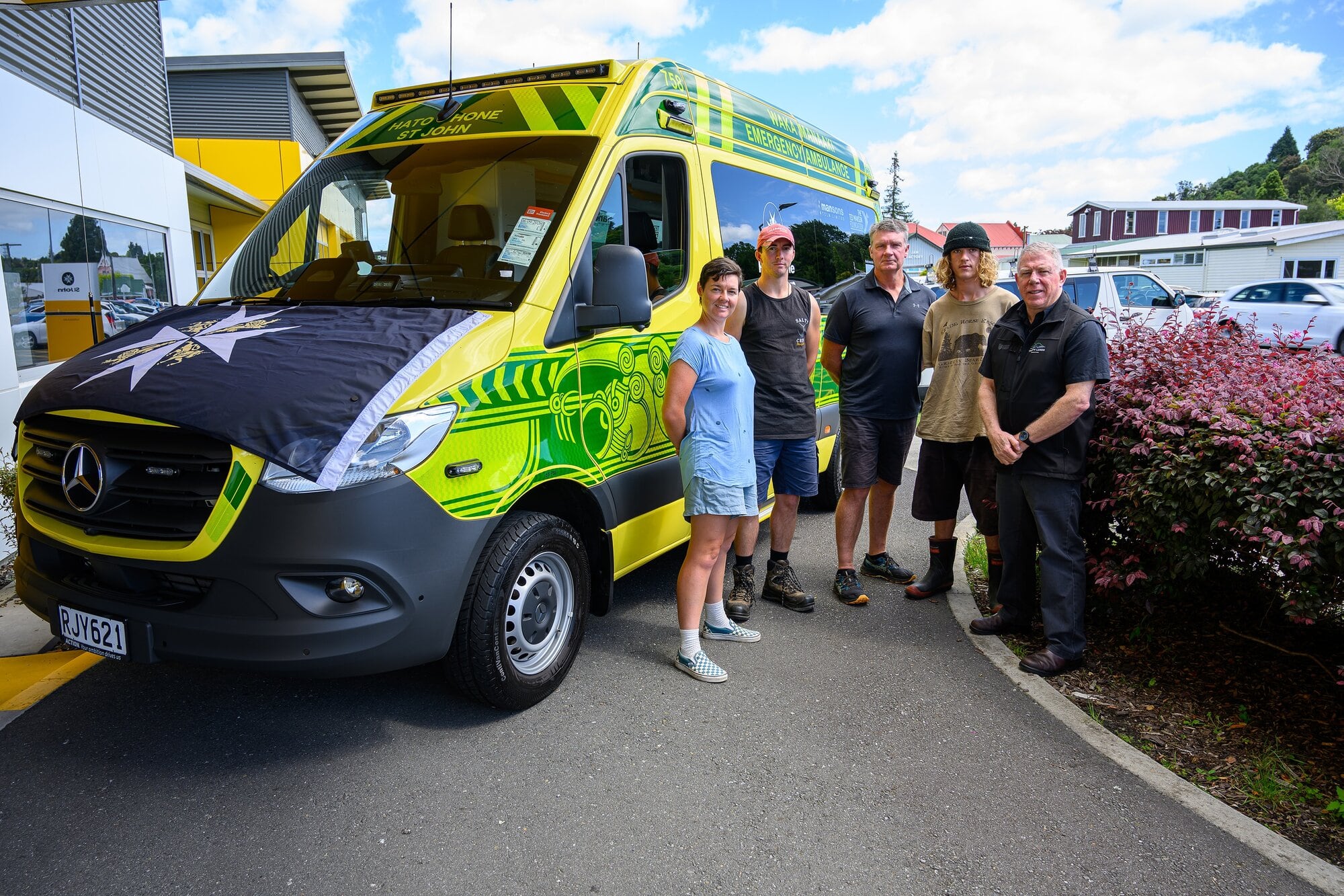 Representatives from horticultural company Trinity Lands Ltd with one of the new ambulances. Photo / David Hall
