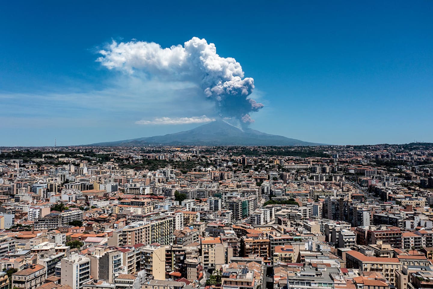 Mount Etna exhibits a Strombolian eruption, with a volcanic plume rising from the southeast crater, on June 02, 2025 in Catania, Italy. An orange aviation warning has been issued. The images show aerial views of the volcano with the city of Catania in the background. Photo / Getty Images