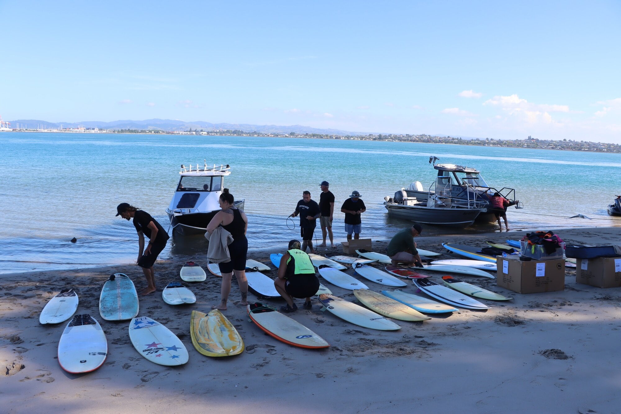 The Bay Boardriders collected 36 surfboards and more than 120 wetsuits for Matakana Island School. Photo / Ayla Yeoman