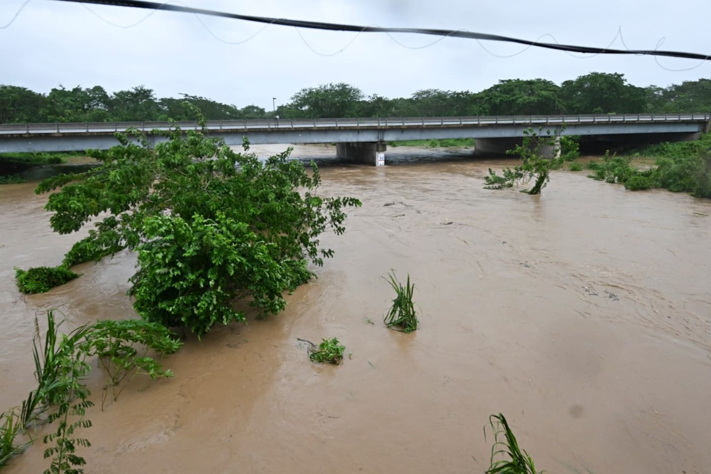 The Rio Cobre bursts its banks near St Catherine, Jamaica, shortly before Hurricane Melissa made landfall on October 28.  Photo / Ricardo Makyn, AFP