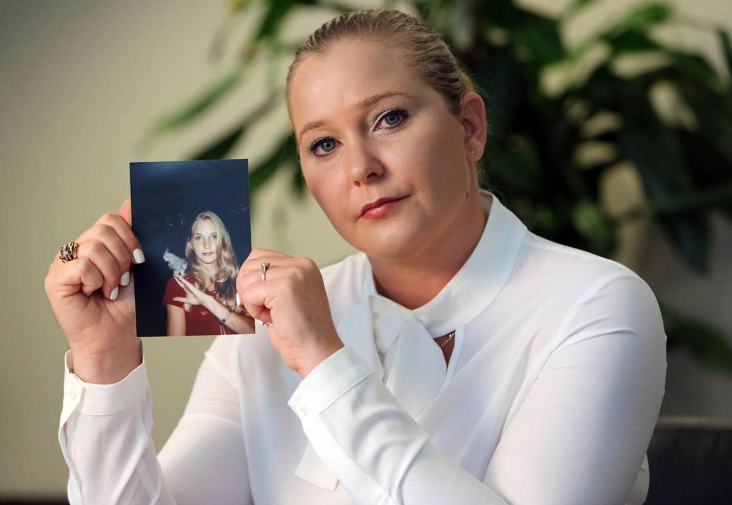 Virginia Giuffre, with a photo of herself as a teen, when she says she was abused by Jeffrey Epstein, Ghislaine Maxwell and Prince Andrew, among others. Photo / Getty Images