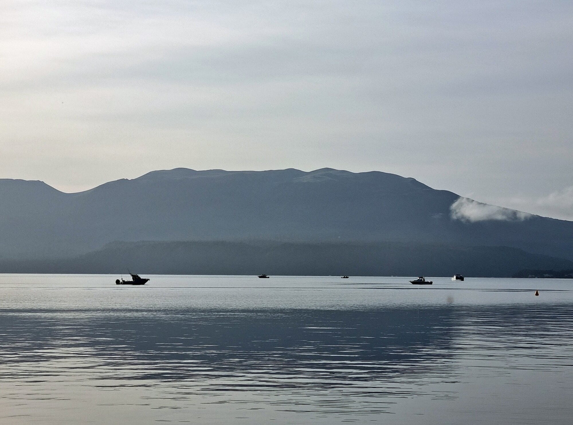  Boats set out onto Lake Tarawera early on opening morning.