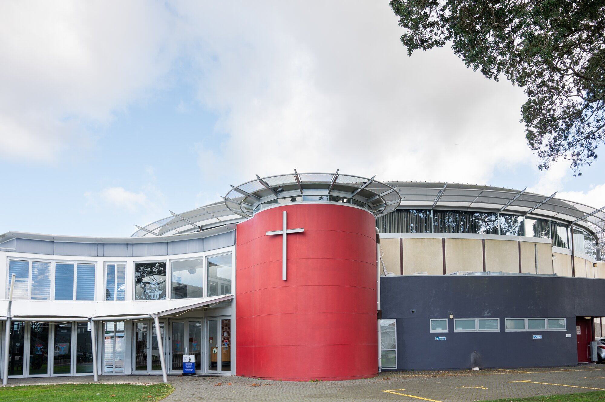 Exterior of the main auditorium of Holy Trinity Tauranga, featuring a cross attached to the circular prayer room. Photo / Brydie Thompson.