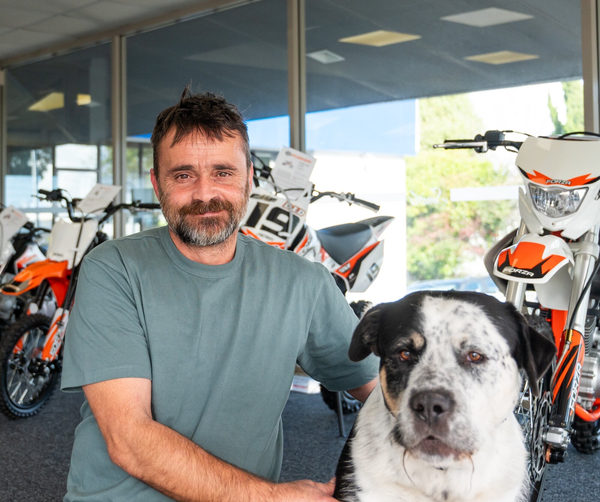 Smith’s Motorcycles owner Joe Szabo and Bear the dog.