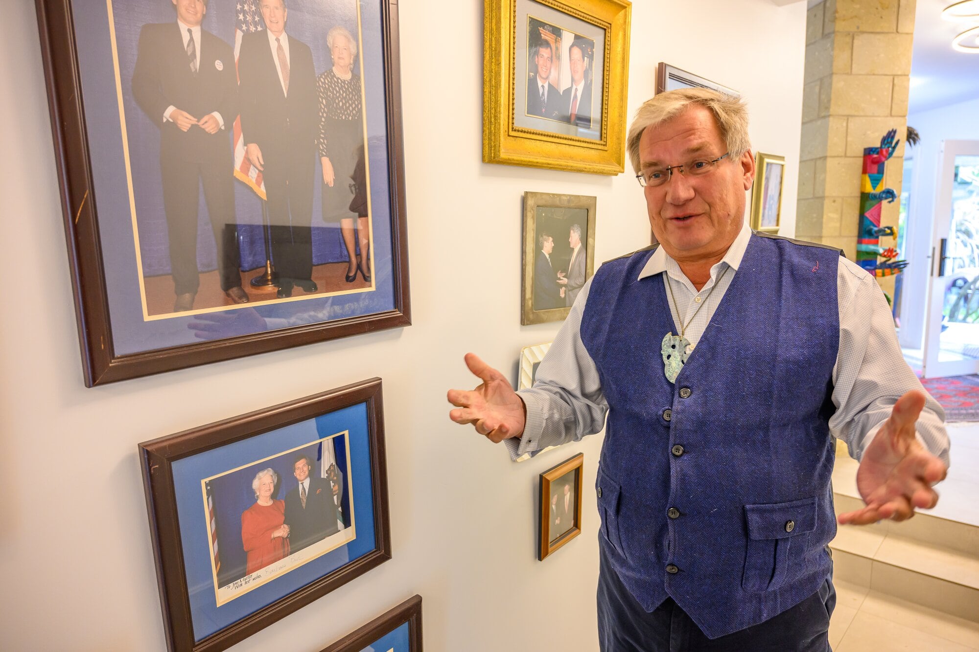 Pert of Jens Mueller's home is lined with photographs of him with US Presidents and global leaders. Photo / David Hall