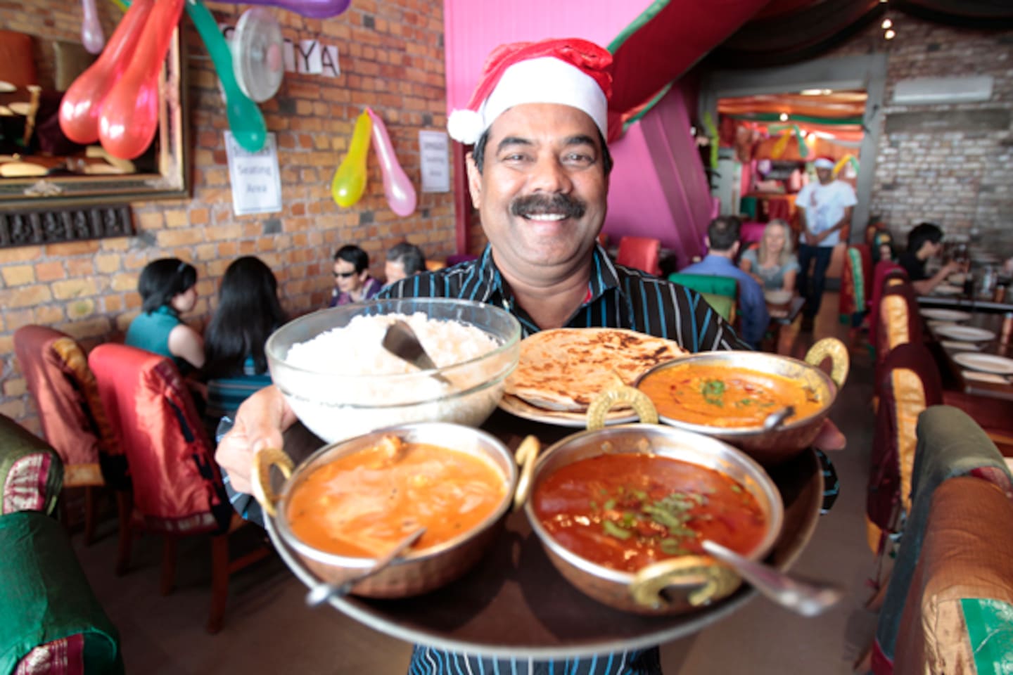 Swamy Akuthota of the Satya South Indian Restaurant chain serves up free Christmas meals for those in need. Photo / Richard Robinson