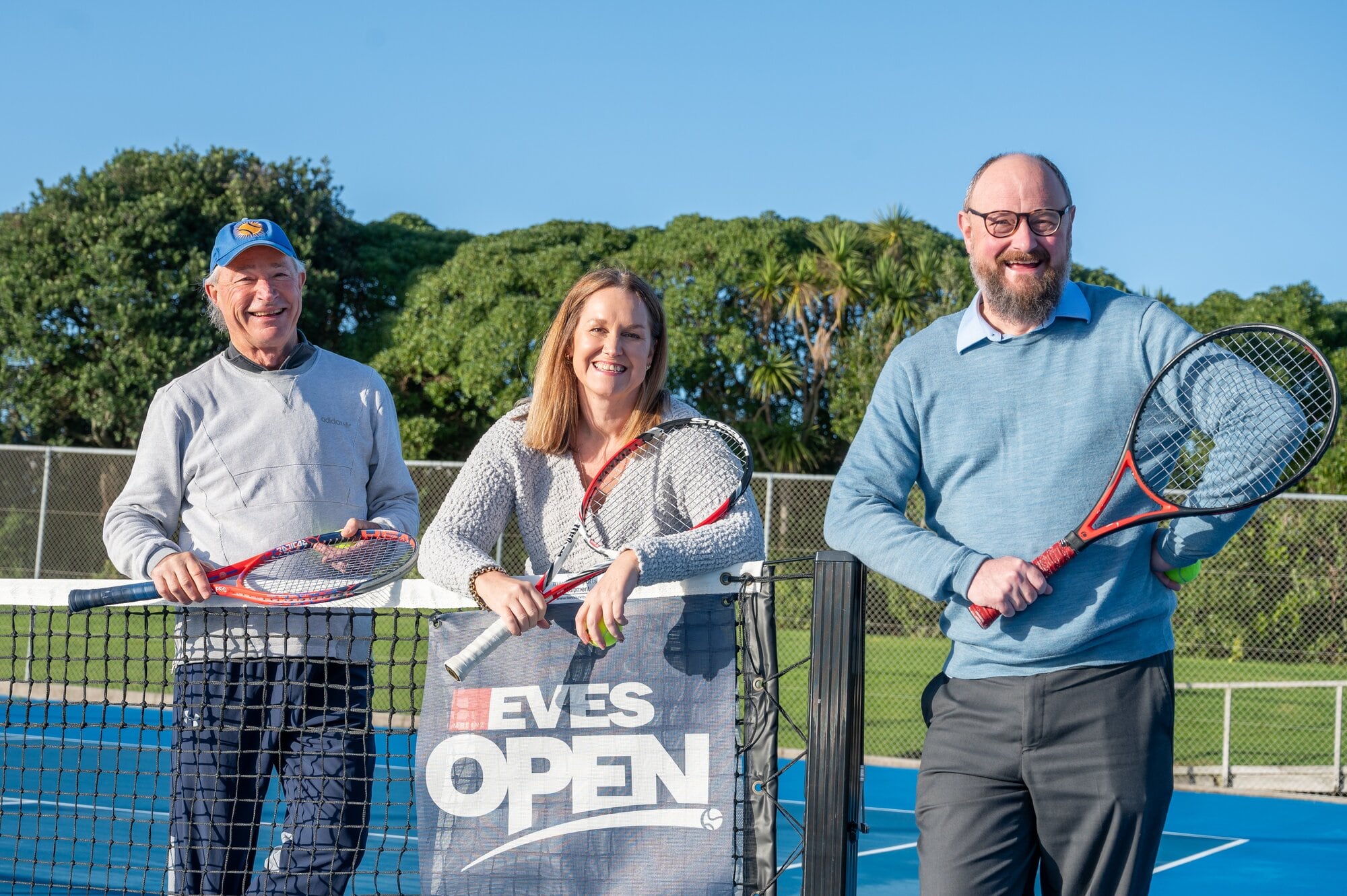  Pāpāmoa Tennis Club president Gerald Greig, EVES Pāpāmoa general manager Meagan Swain-son and Pāpāmoa Ward Councillor Steve Morris can’t wait for the EVES Open to return this De-cember. Photo / Brydie Thompson