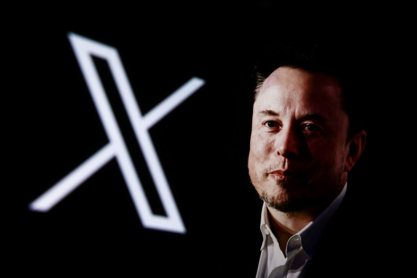 Businessman Elon Musk, next to a logo for his X platform, worked in the White House early this year. Photo / Getty Images