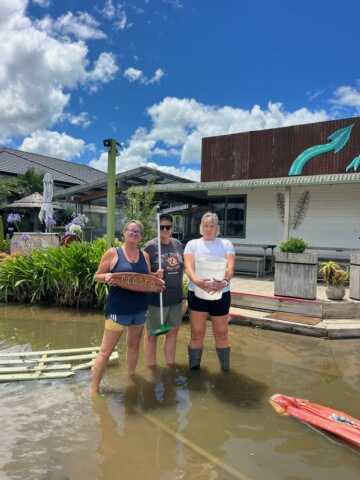 Surf Shack eatery owners Joanne and Pip Coombes, with Victoria Lemon (far right), the owner of Victoria Lemon Transform Today gym, outside their flooded businesses. Photo / Victoria Lemon