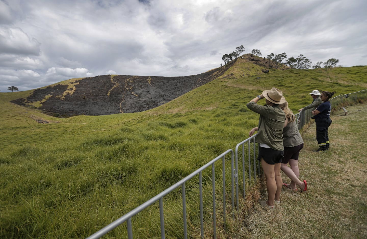 Walkers at Māngere Mountain see the aftermath of the fire on the maunga.
Photo / Alex Burton