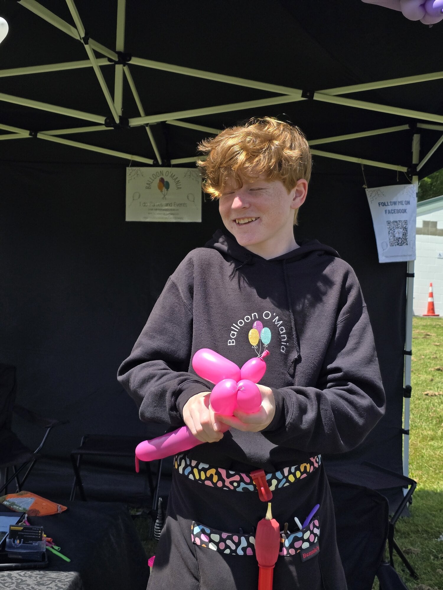 Kieran Grove making balloon sculptures at the Fairhaven School Gala and Fireworks event.