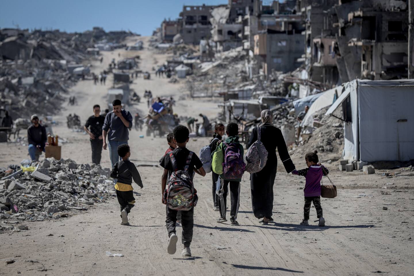 Palestinian residents flee the conflict zones by car, on donkey carts, and on foot, carrying their belongings to safer areas following intense Israeli military attacks. Photo / Getty Images