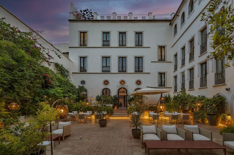 An elegant courtyard dining setting at The Corners of the Marquis.