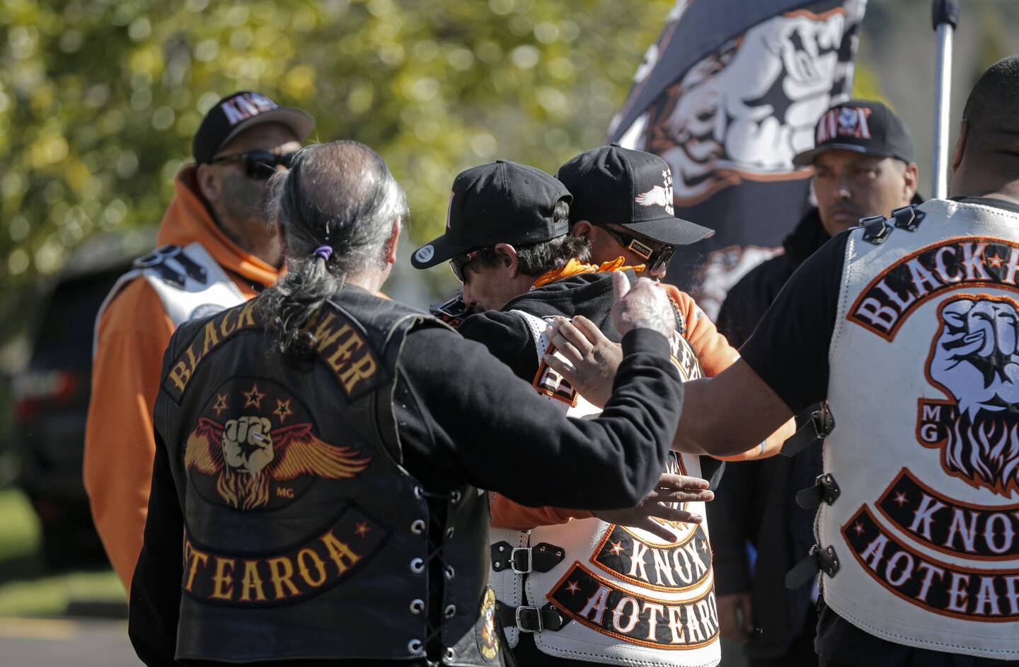The grieving husband of Jo Sione-Lauaki, Jared Sione-Lauaki, (centre) being hugged by mourners. Photo / Alex Burton