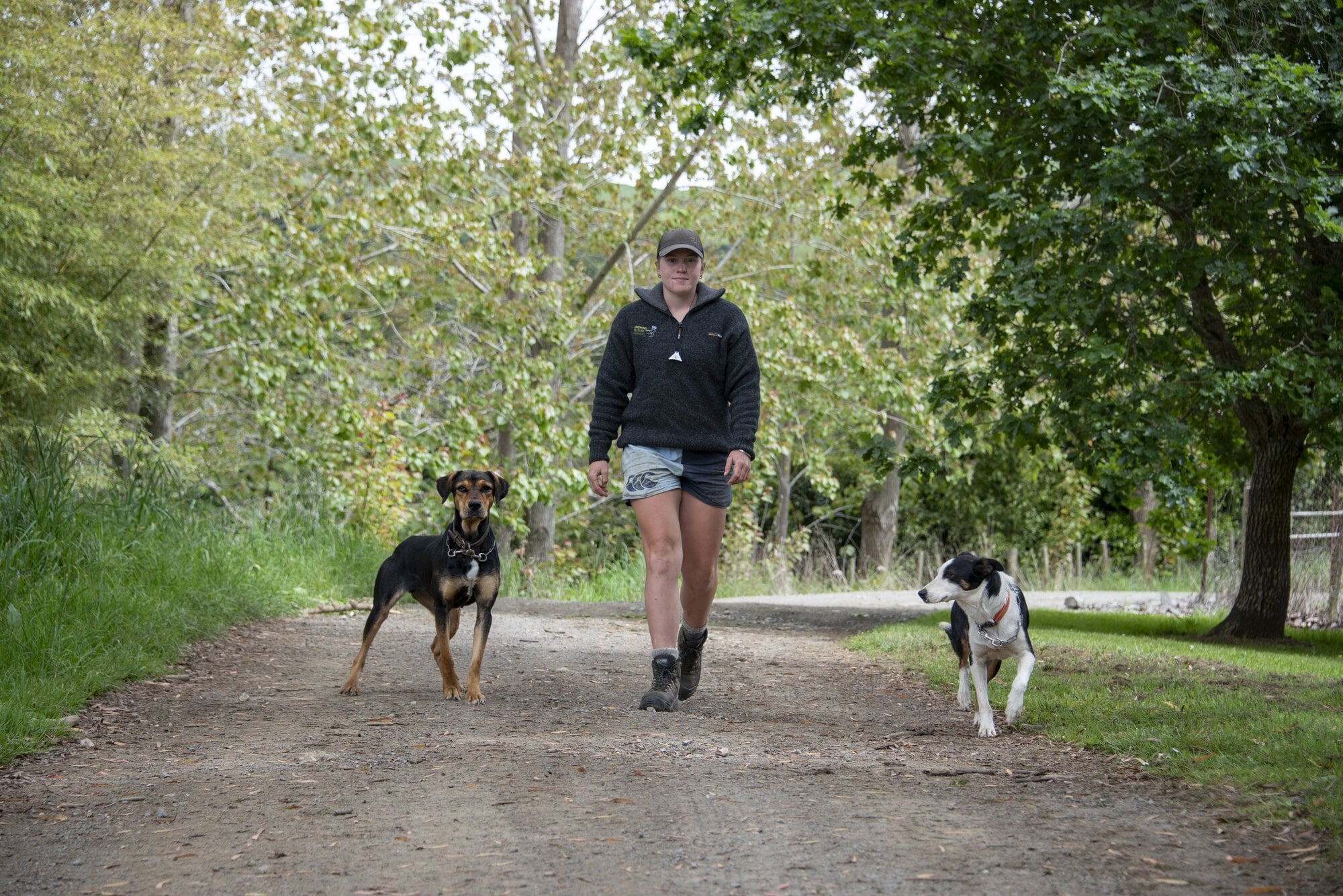 Growing Future Farmers graduate Jess Cameron with her huntaway Cam (left) and heading dog Smoke (right). Photo / Catherine Fry