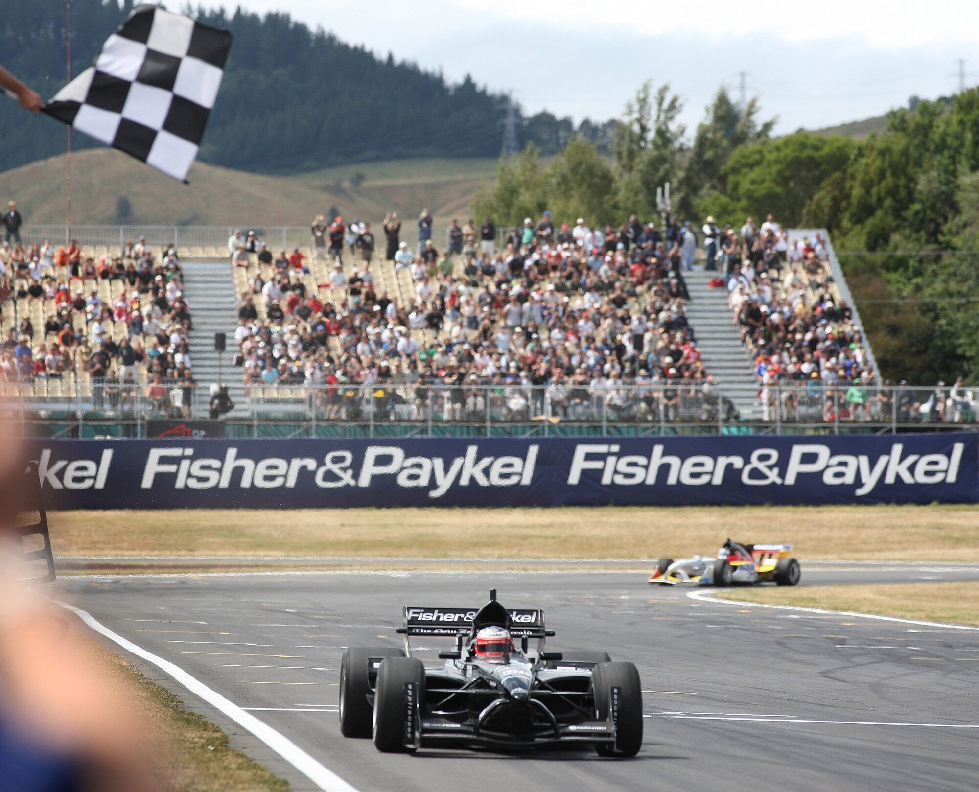 Jonny Reid and A1 Team New Zealand take the checkered flag to win the Sprint race in Taupō in January 2008. Photo / Andrew Cornaga/PHOTOSPORT