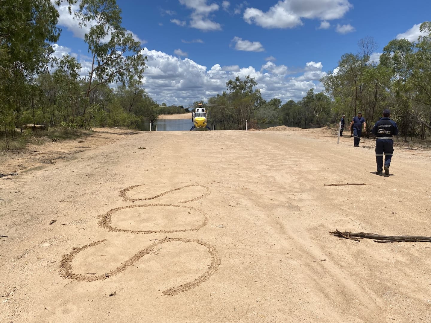 An 'SOS' sign a couple wrote in the dirt in the Gulf Country in North West Queensland, Australia, after getting stranded when their 4WD was swept away by flood waters. Photo / LifeFlight