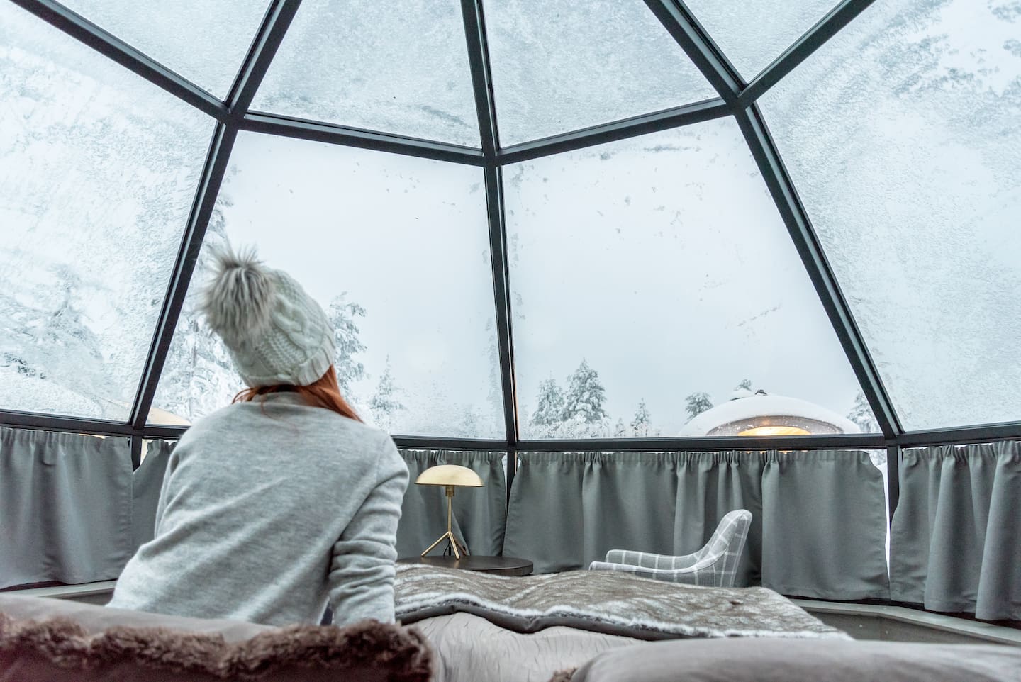 Glass igloos in Saariselkä offer a warm place to view the snow-capped surroundings and Northern Lights from your bed. Photo / 123rf