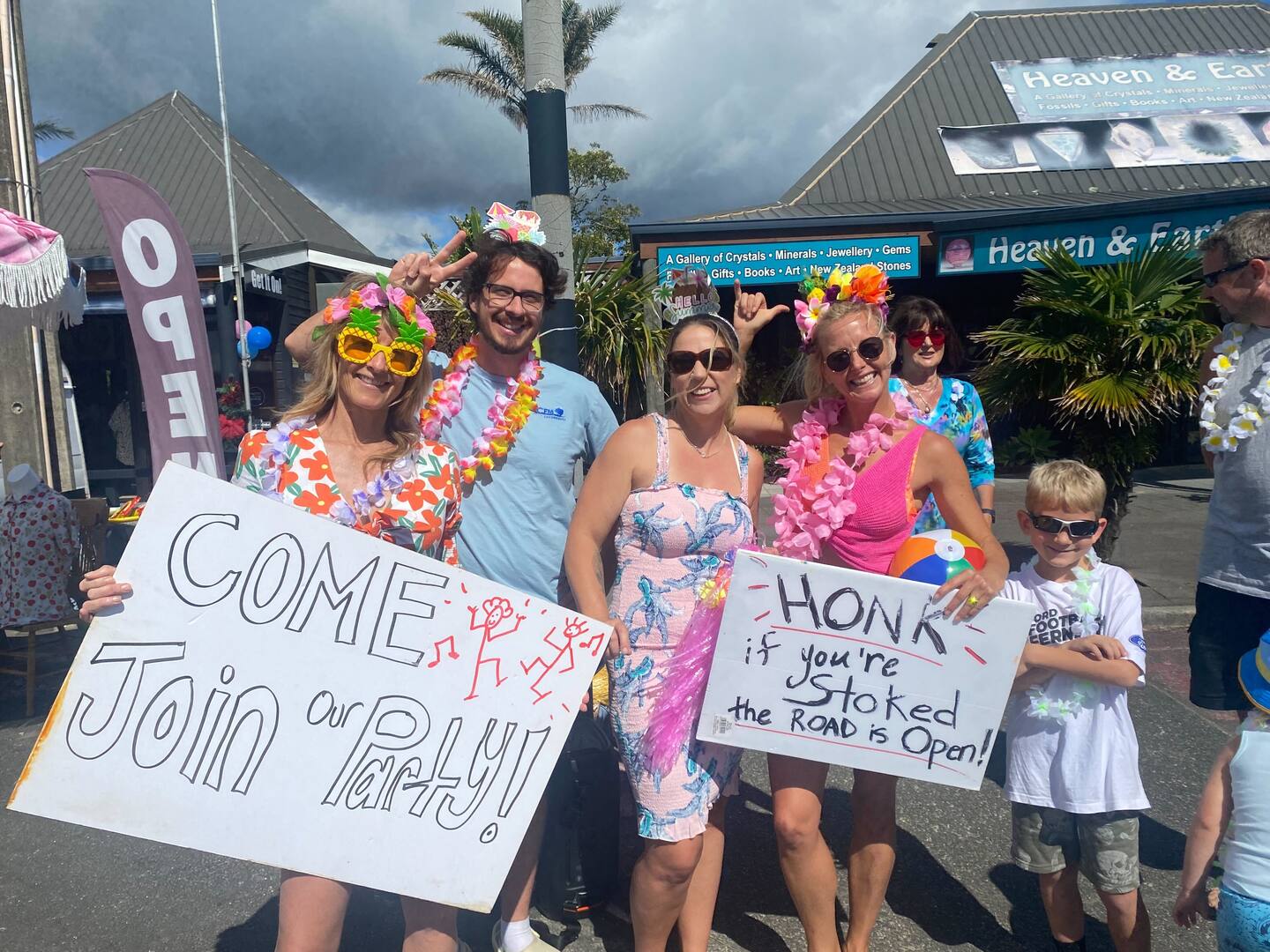 Coromandel residents in Tairua party on the streets as they welcome tourists back travelling on the reopened SH25A bridge in December 2023. Photo / Cheree Kinnear