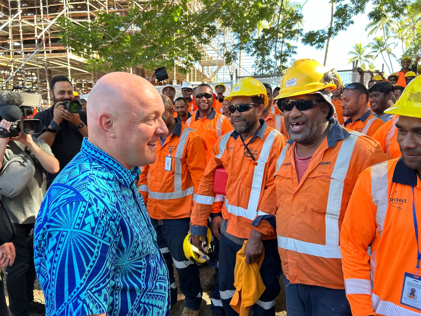 Prime Minister Christopher Luxon speaking with workers on a Fletcher development site in Fiji. Photo / Adam Pearse