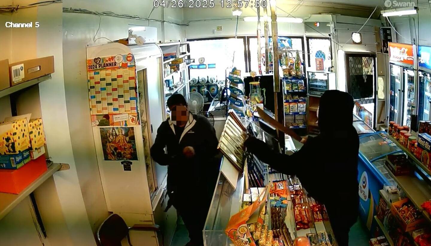 The footage shows the staff member putting cigarettes into the robber's backpack.