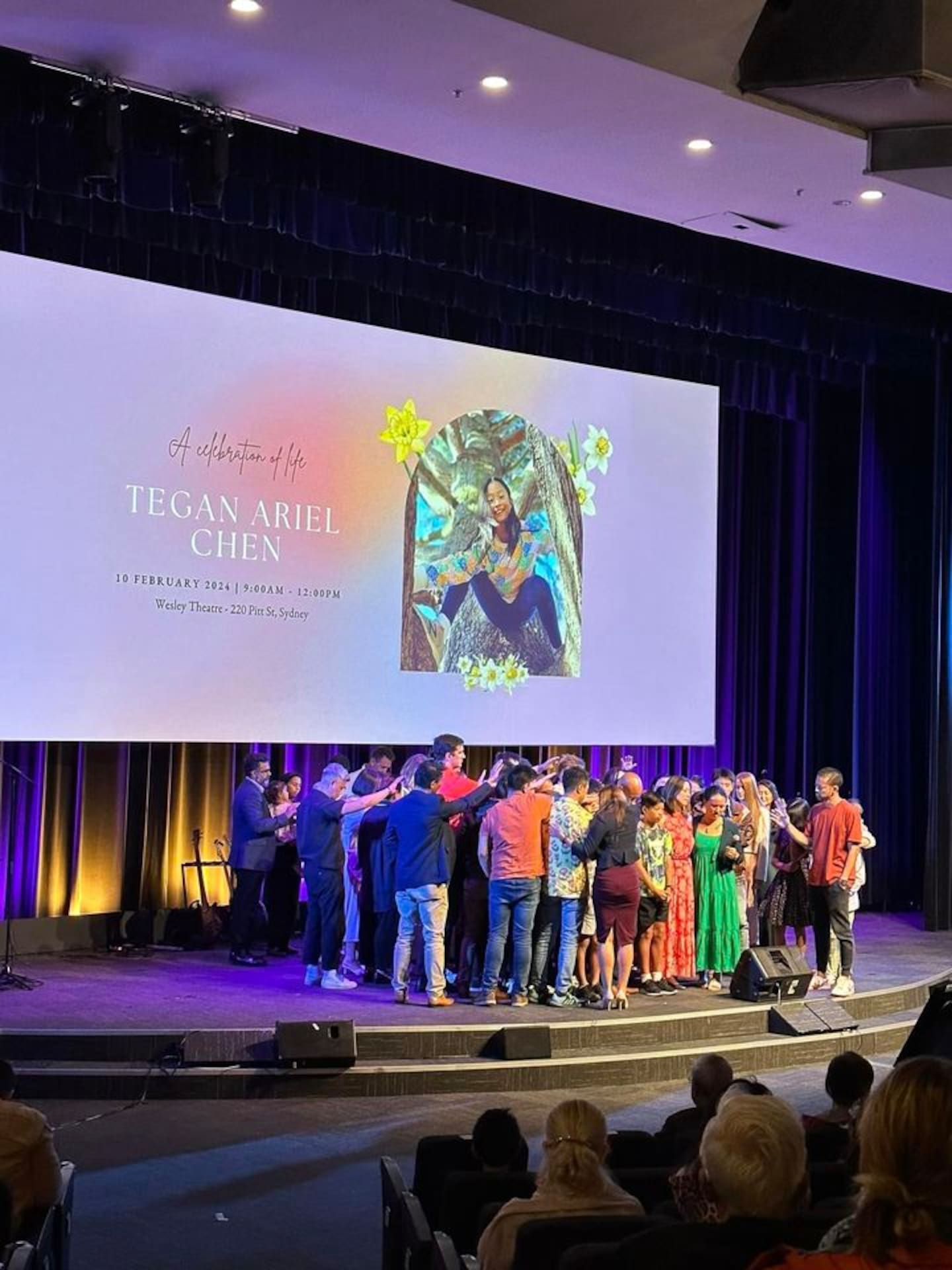 Loved ones pray for Tegan's family at a service celebrating her life.