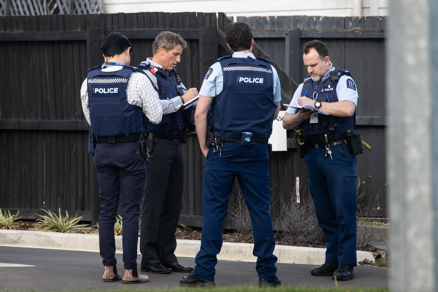 Detectives at a house on Barrington St, Spreydon, Christchurch, this afternoon. Photo / George Heard