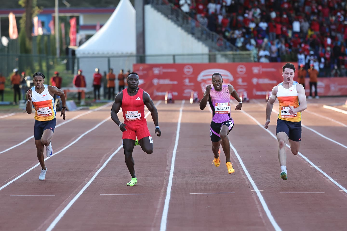 Australia's Lachlan Kennedy (right) charges to the finish line ahead of South Africa's Bayanda Walaza (second right) and Kenya's Ferdinand Omanyala (second left), who came second and third respectively, during the men's 100m event at the ABSA Kip Keino Classic in Kenya. Photo / AFP