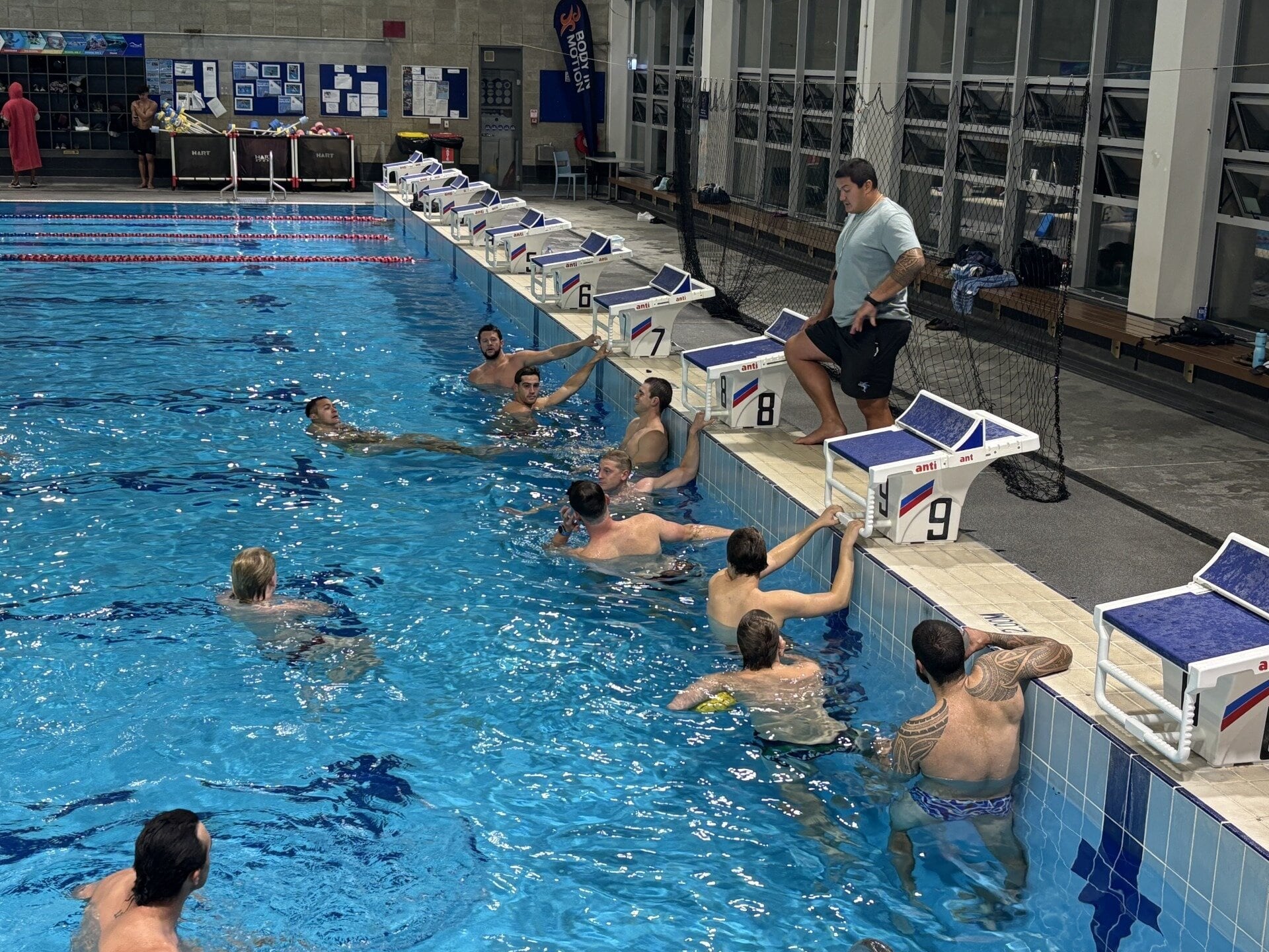 Tauranga men's water polo team coach Joe Kayes with the team before practice. Photo / Mark Edgecombe