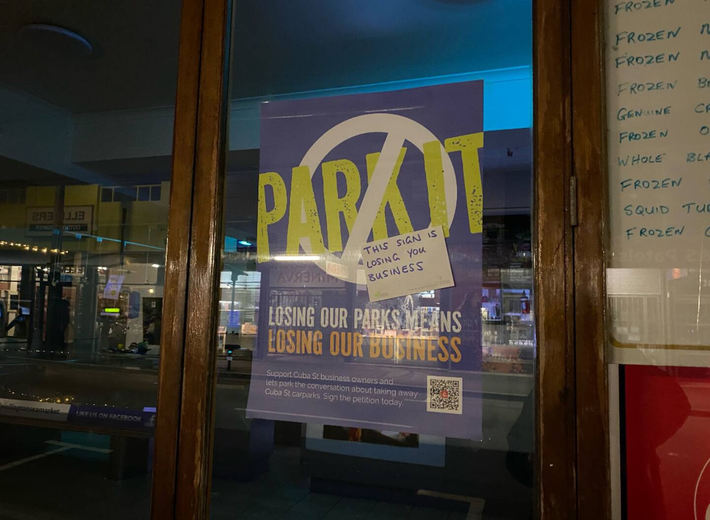 Opposing views on car park reduction were evident during the weekend's CubaDupa festival, with counter-signs being posted on signs in shop windows. Photo / Ethan Manera