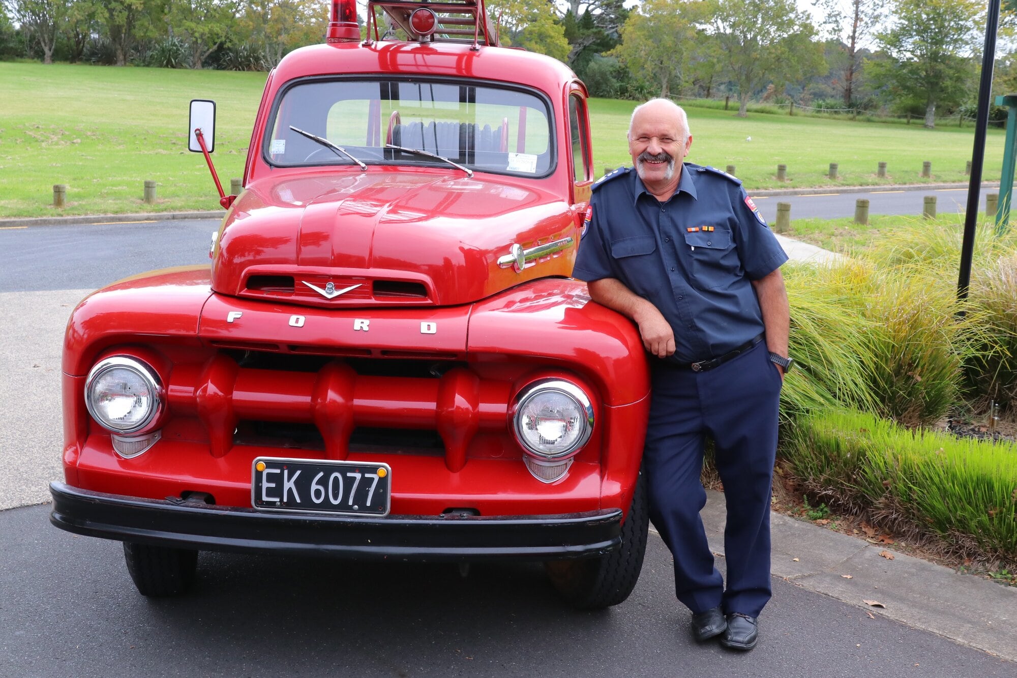 Katikati Volunteer Fire Brigade chief fire officer Craig Gray with his brigade’s old fire appliance – a converted 1953 Ford truck. Photo / Kelly O’Hara